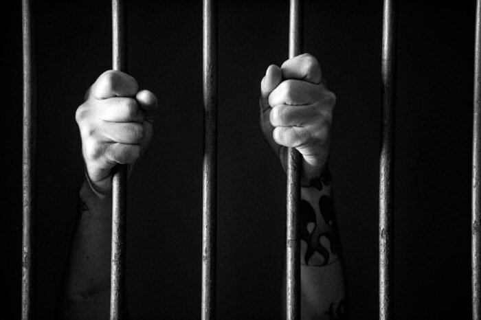 prison-bars-with-hands